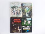 several books are sitting on a white surface with a white background