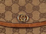 a guccissi wallet with a gold buckle on the front