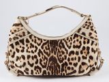 the leopard print purse is on display on a white surface