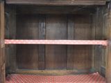 a wooden shelf with a red and white checkered floor