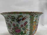 a green bowl with a bird and flowers design on it