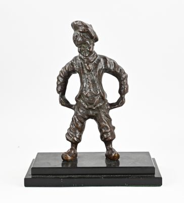 a bronze statue of a man standing on a black base