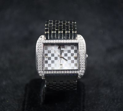 a close up of a watch on a black surface
