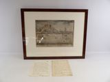 framed picture of a couple of old papers sitting on a table