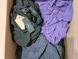 a cardboard box filled with clothes and a tag