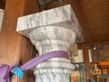 a purple ribbon tied to a pillar in a room