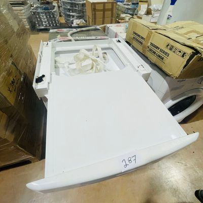 an image of a white washing machine in a warehouse