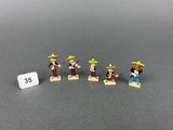 five toy figurines of a man with a guitar and a woman with a hat