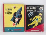 two books on a white surface one is a rocket and the other is a space shuttle