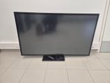 a large flat screen tv sitting on top of a tiled floor