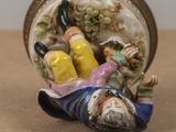 a small figurine of a man laying on a table
