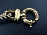 a close up of a metal clasp on a black surface