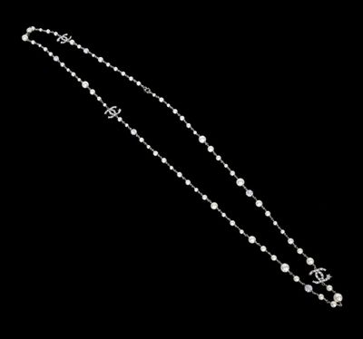 a close up of a necklace on a black background