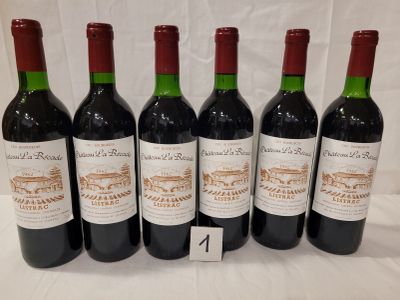 six bottles of wine are lined up on a table