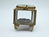 a small glass box with a stone inside of it