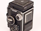 a black and white photo of an old camera