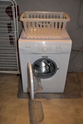 a washing machine with a basket on top of it