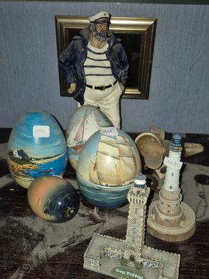 a statue of a sailor on a table with other items