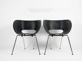 two black chairs sitting next to each other on a white surface