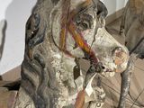 a wooden horse that is sitting on the floor