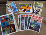 a lot of comic books sitting on a table