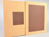 an open book with a brown cover sitting on top of a table