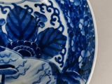 a blue and white plate with a bird on it