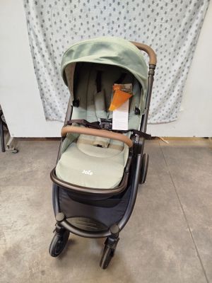 a baby stroller with a baby in it in a room