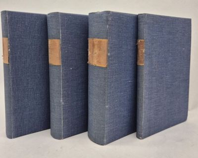 three blue books are lined up on a white surface