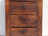 an old wooden chest of drawers with four drawers on top of it