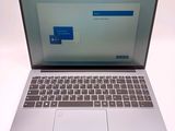 a laptop that is open on a white surface