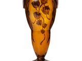 a brown vase with a floral design on it
