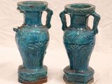 two blue vases that are sitting on a table