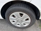a white car that is parked on the side of the road