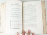 a person holding an open book in their hand