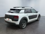 the back of a white car with a surfboard on top of it