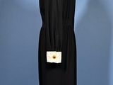 an image of a black dress on a mannequin stand
