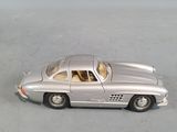 a silver toy car that is sitting on a table