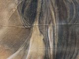painting of a woman ' s face on a wall with a sky background
