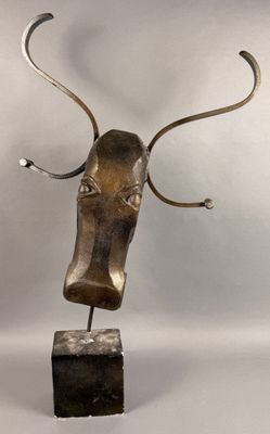 bronze sculpture of a bull ' s head with horns on a wooden base