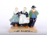a figurine of a man and a woman on a sled