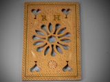 carved wooden plaque with the word drh on it