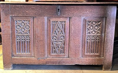 a wooden chest with carvings on the front of it