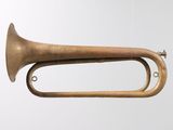a brass trumpet hanging from the ceiling in a room