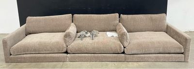 a couch that is sitting on the floor in front of a blackboard