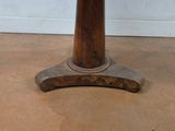 a small table with a wooden base on the floor
