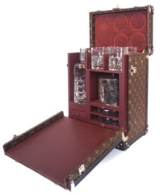 an image of a suitcase with a liquor set inside of it