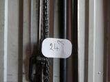 a sign hanging on a door with a chain attached to it