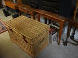 a wicker basket sitting on the floor in front of a television