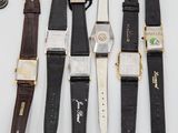 several different types of watches are lined up on a white surface